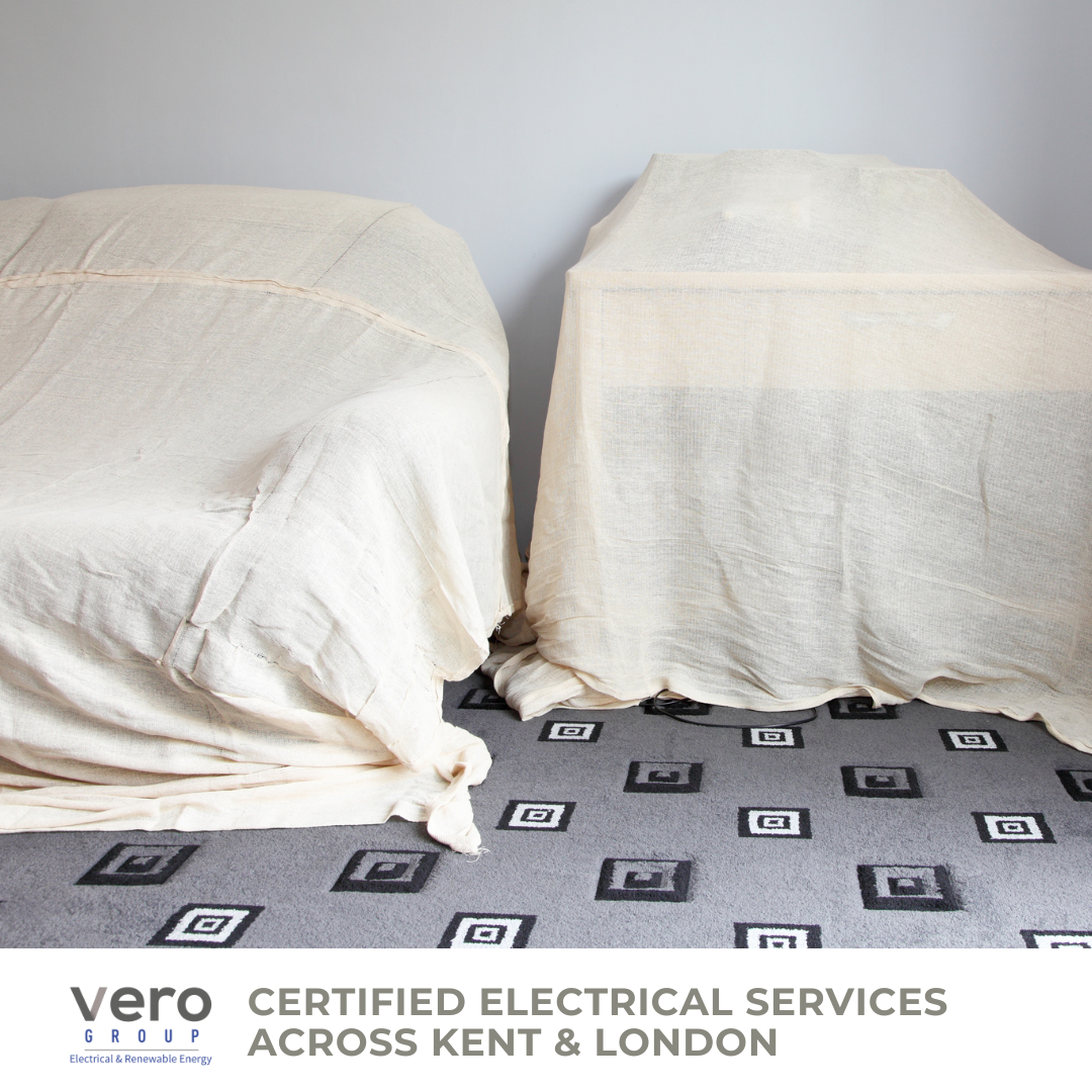 Furniture covered with dust sheets during rewiring work